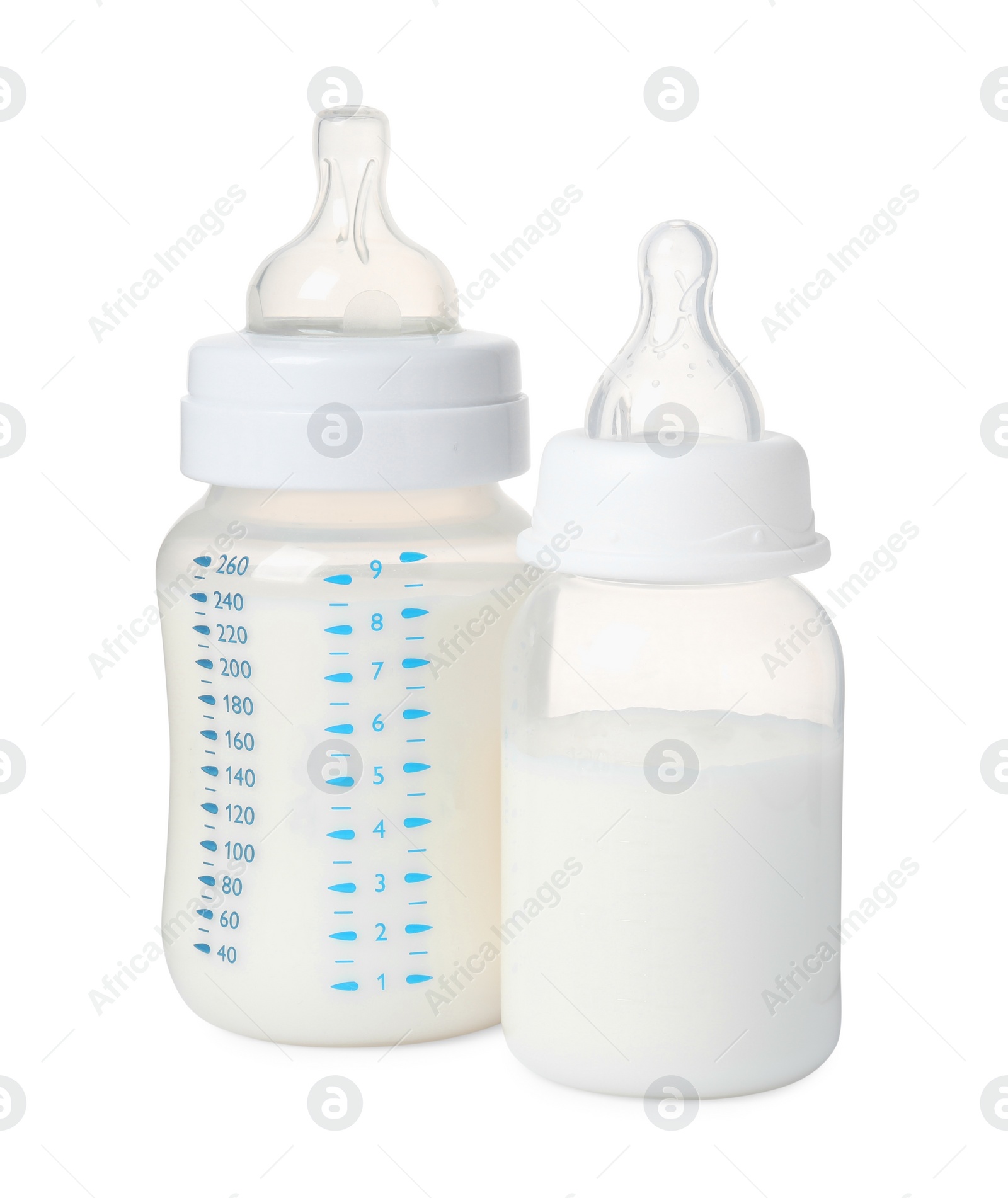 Photo of Two feeding bottles with infant formula on white background