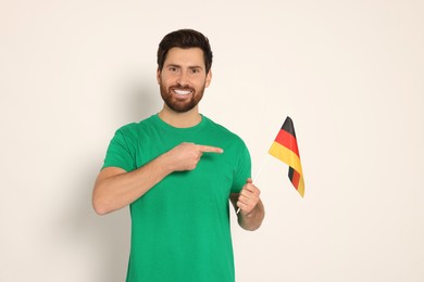 Man with flag of Germany on white background