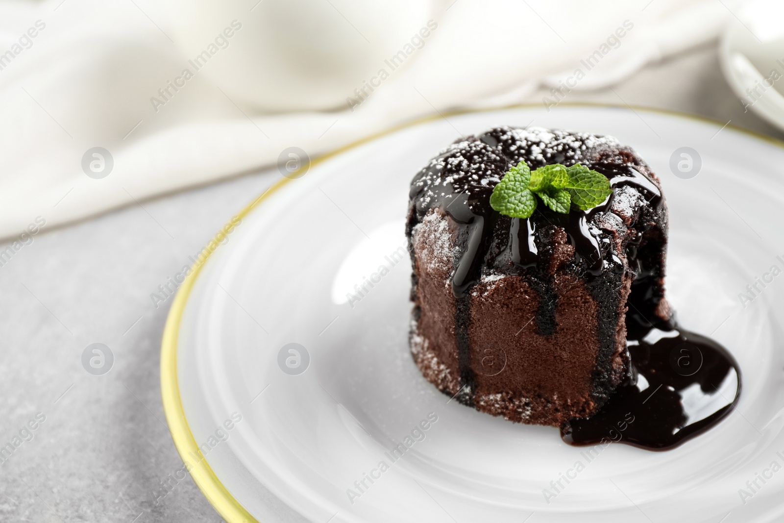 Photo of Delicious warm chocolate lava cake on plate, closeup