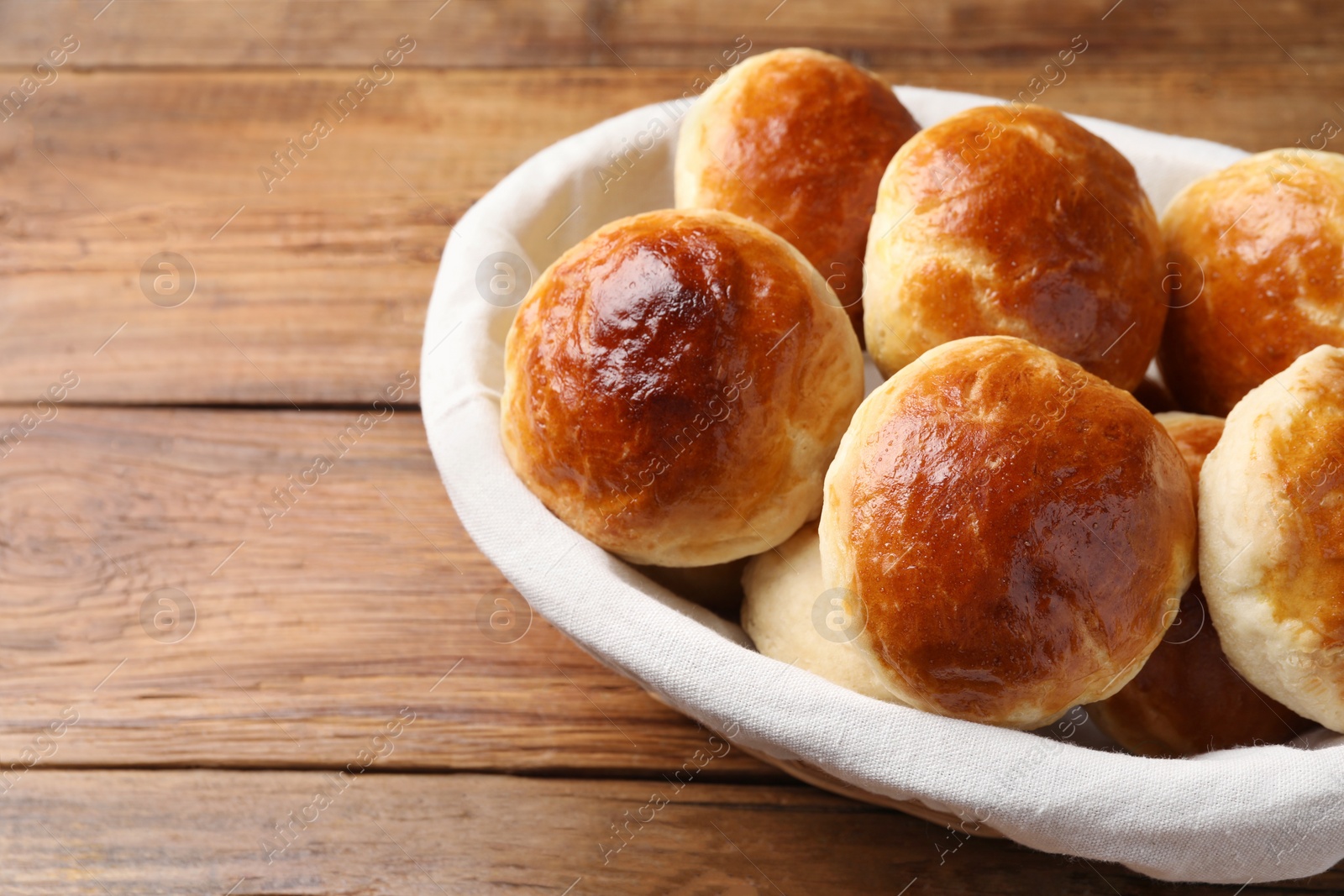 Photo of Tasty scones prepared on soda water on wooden table, space for text