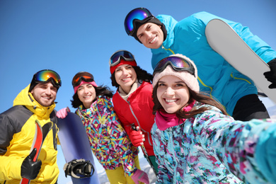 Group of friends taking selfie outdoors. Winter vacation