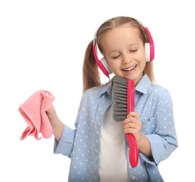 Photo of Cute little girl with brush and rag singing on white background