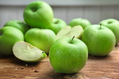 Photo of Fresh green apples on wooden table