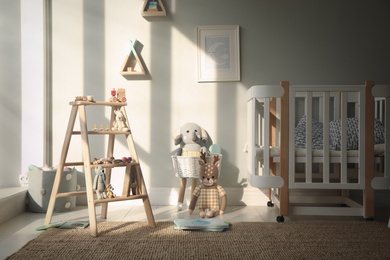 Photo of Beautiful baby room interior with stylish wooden ladder