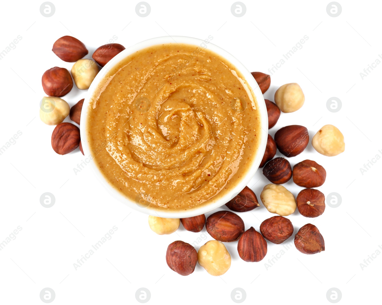 Photo of Delicious nut butter and hazelnuts isolated on white, top view