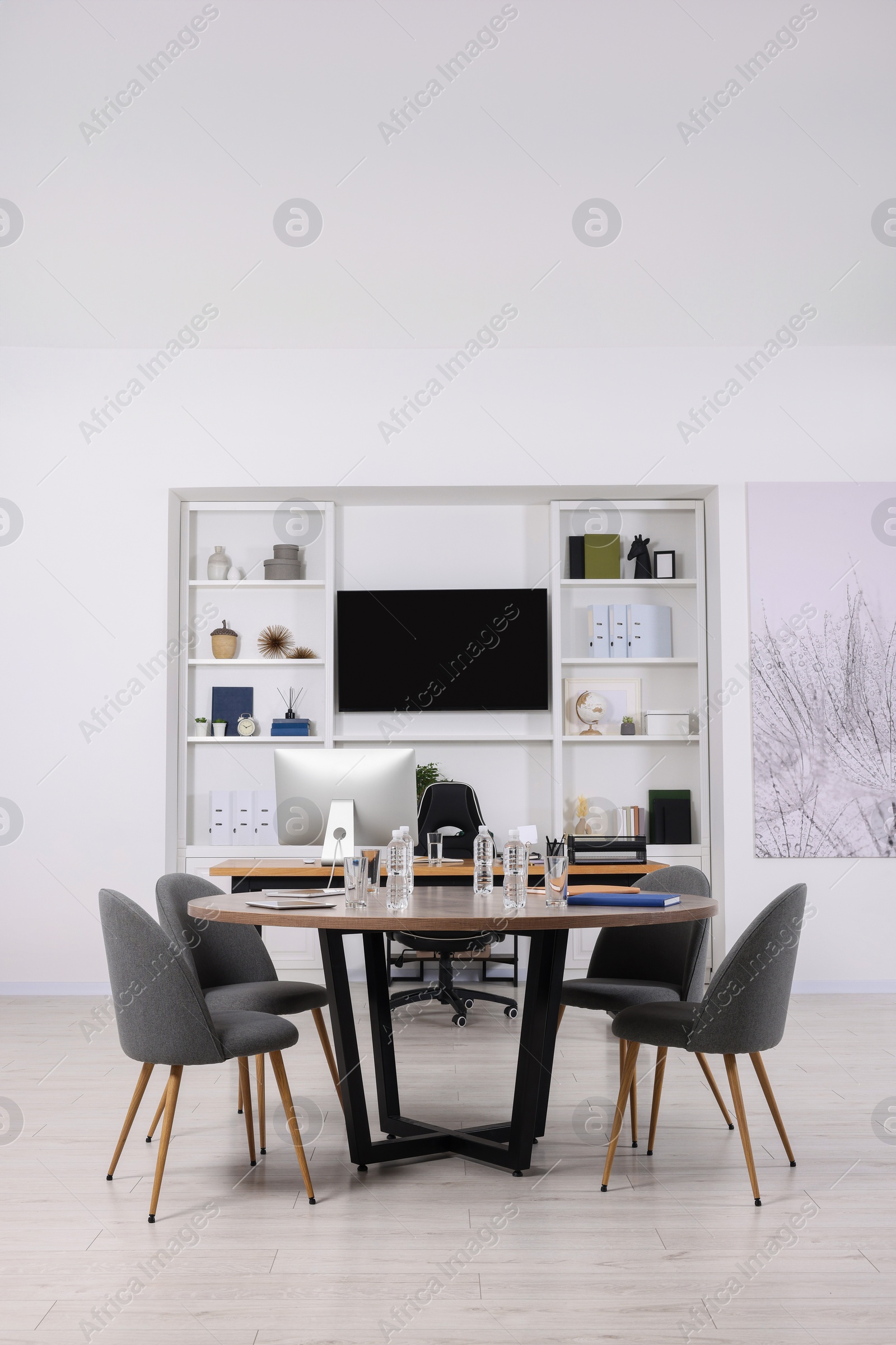 Photo of Stylish office with comfortable furniture and tv zone. Interior design