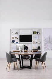 Stylish office with comfortable furniture and tv zone. Interior design