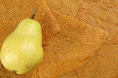 Photo of Pear on delicious fruit leather, top view. Space for text