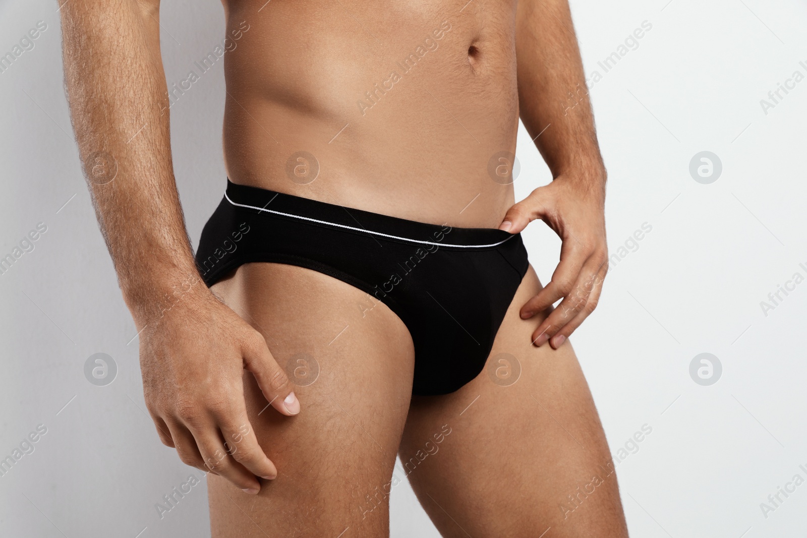 Photo of Man in black underwear on white background, closeup