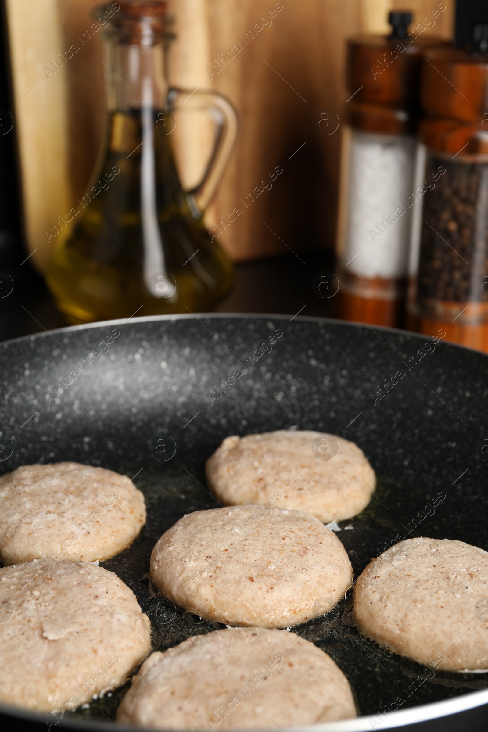 Photo of Cooking vegan nuggets in frying pan, closeup