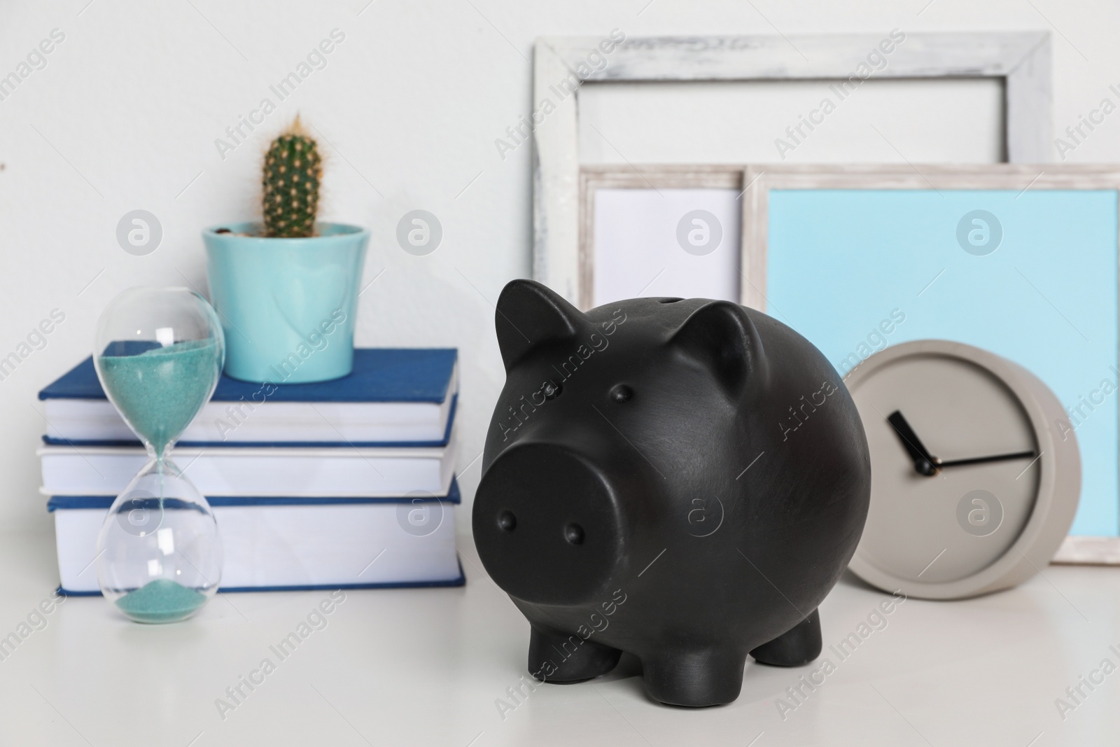 Photo of Color piggy bank on table in room. Cute interior element