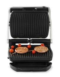 Electric grill with homemade sausages and fresh tomatoes isolated on white