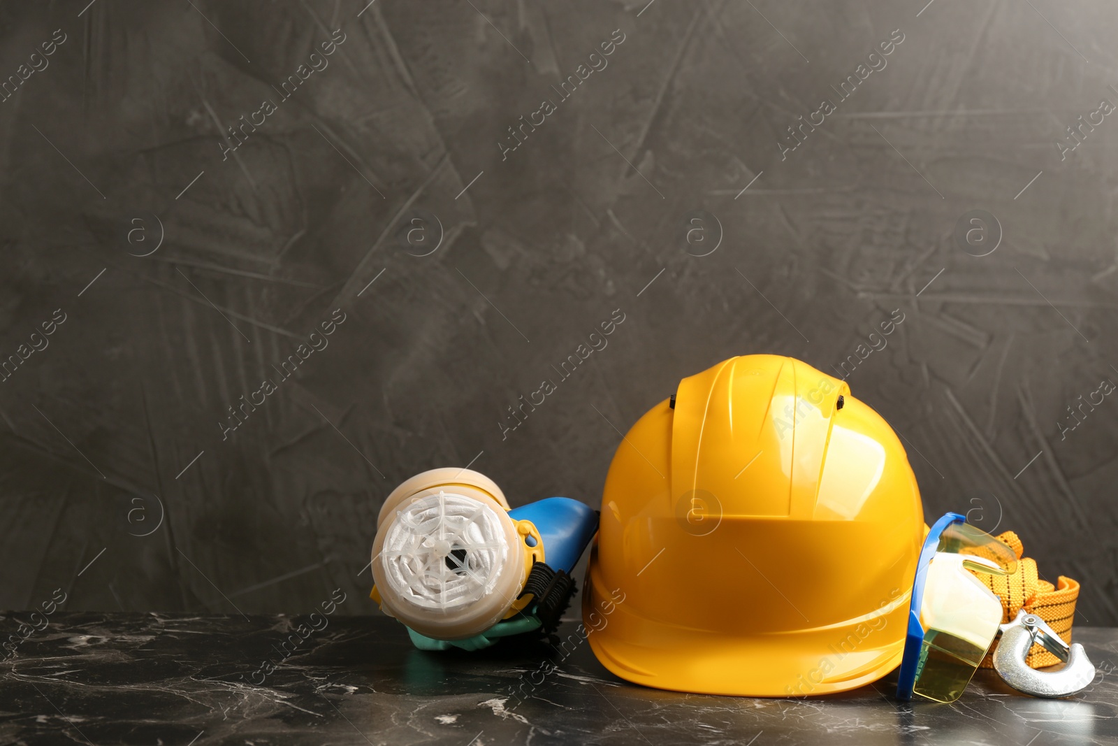 Photo of Composition with safety equipment on table against grey background. Space for text