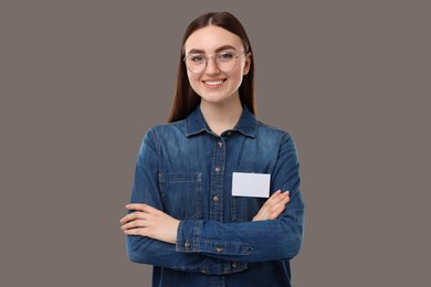 Photo of Happy woman with blank badge on grey background