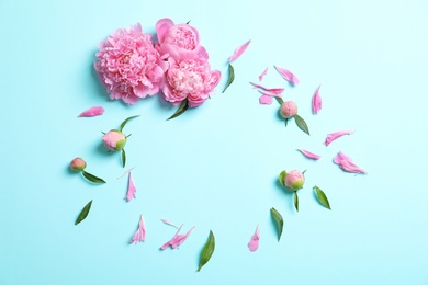 Composition with beautiful peony flowers on color background