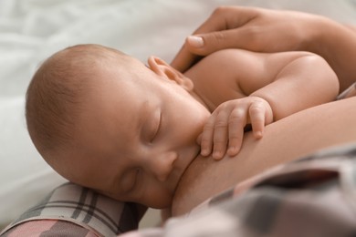 Young woman breastfeeding her little baby, above view