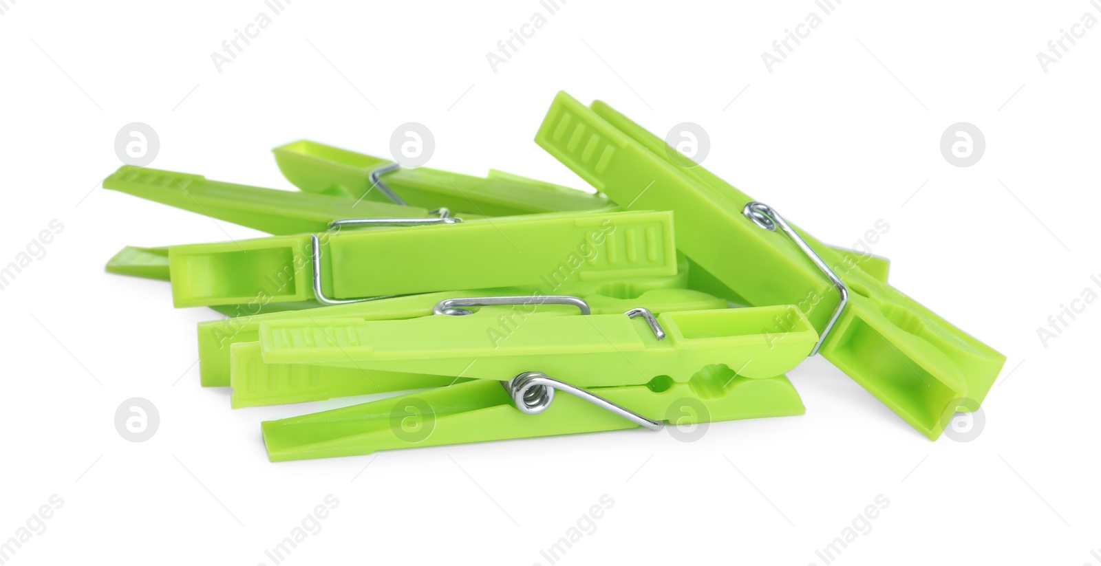 Photo of Bright green plastic clothespins on white background