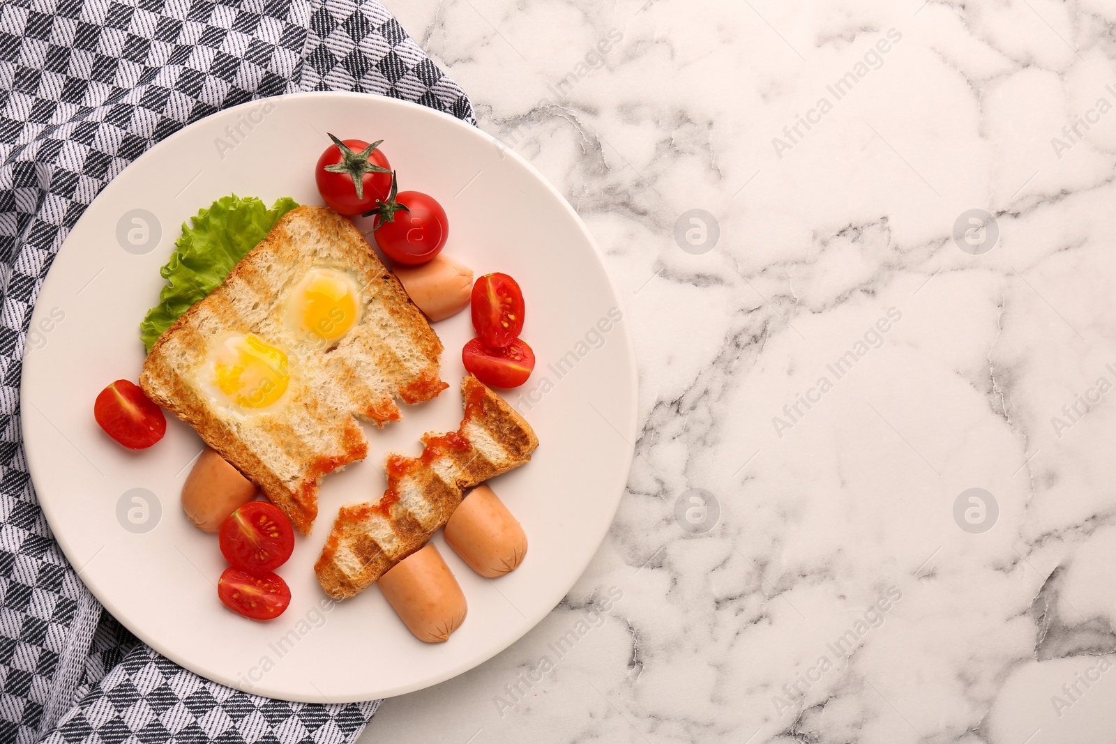 Photo of Cute monster sandwich with cherry tomatoes, fried eggs and sausages on white marble table, flat lay and space for text. Halloween snack