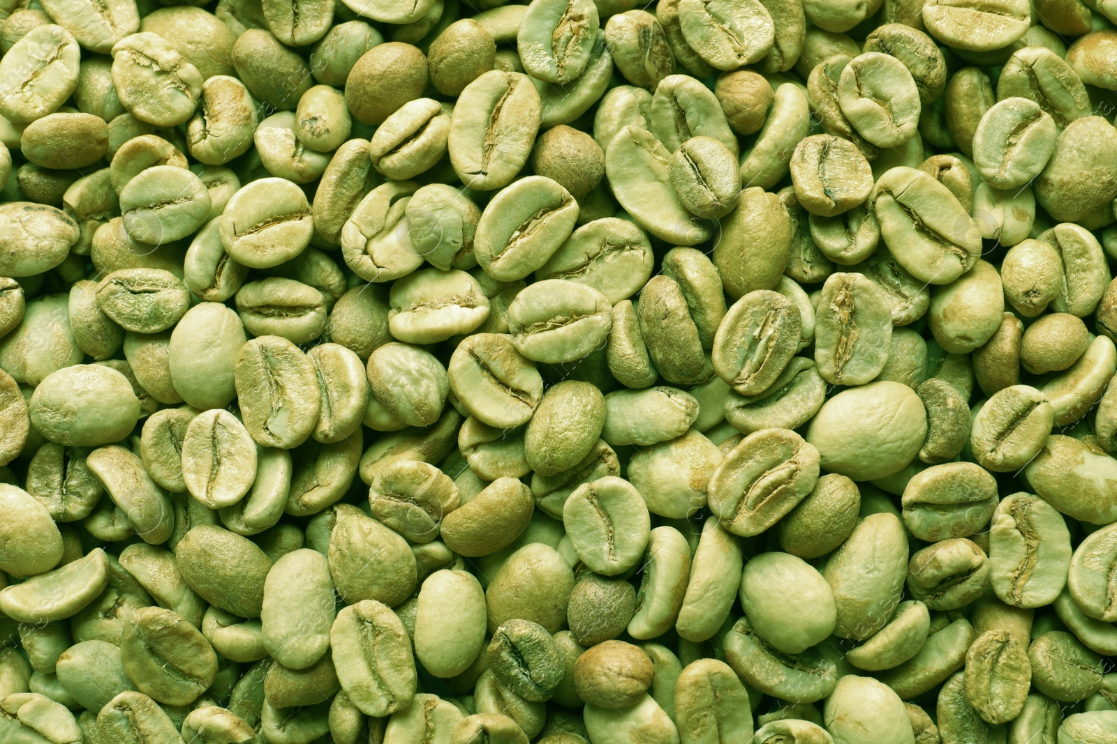 Photo of Many green coffee beans as background, top view