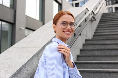 Photo of Portrait of beautiful woman in glasses outdoors, space for text