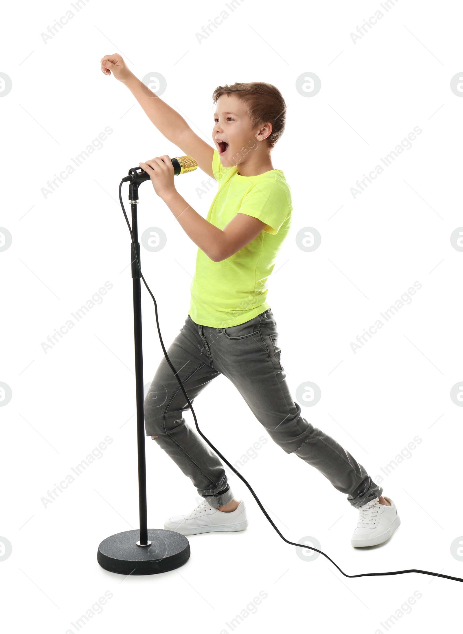 Photo of Cute boy singing in microphone on white background
