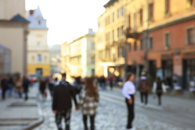 Blurred view of people walking on city street