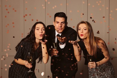 Photo of Friends with glasses of sparkling wine celebrating New Year indoors