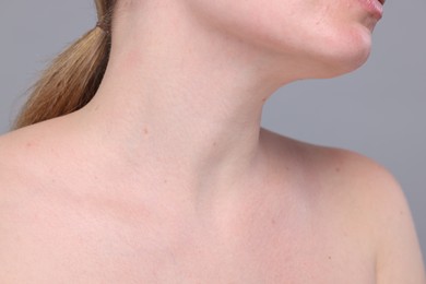 Photo of Closeup view of woman with normal skin on grey background