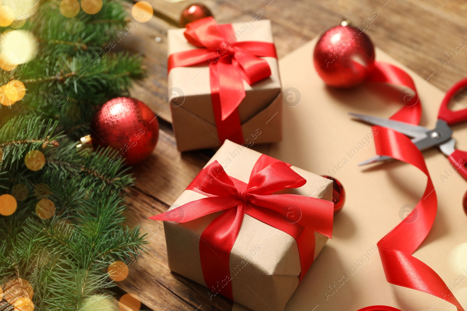 Photo of Christmas gift box and decor on wooden table, closeup