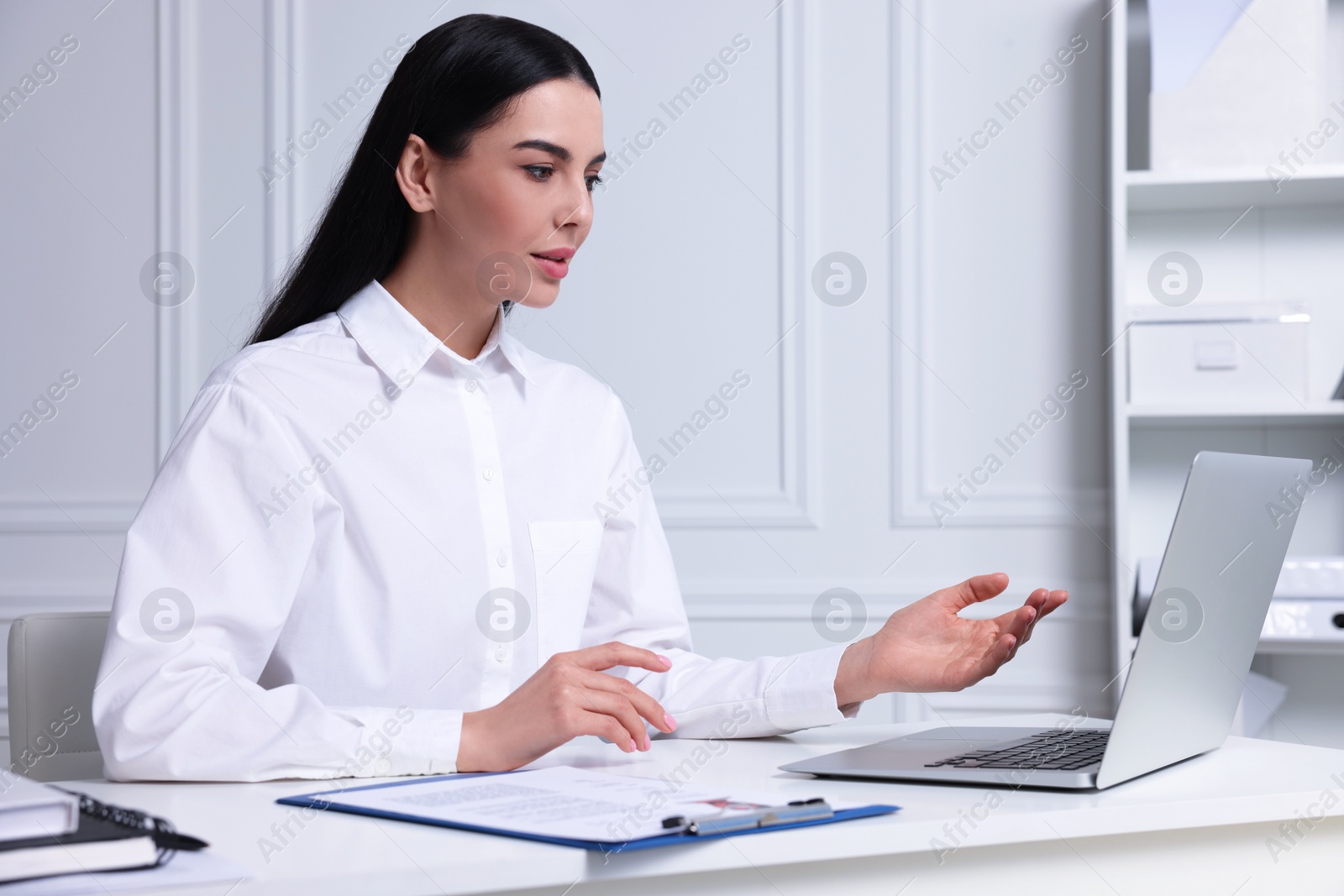 Photo of Human resources manager conducting online job interview via video chat on laptop