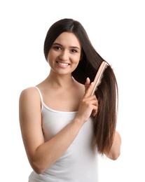 Beautiful young woman with hair comb on white background