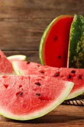 Photo of Delicious fresh watermelon slices on wooden table