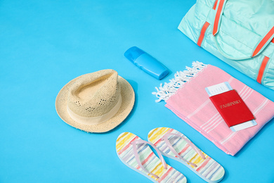 Photo of Bag and travel accessories on blue background
