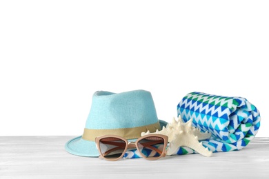 Set of beach accessories on table against white background. Space for text