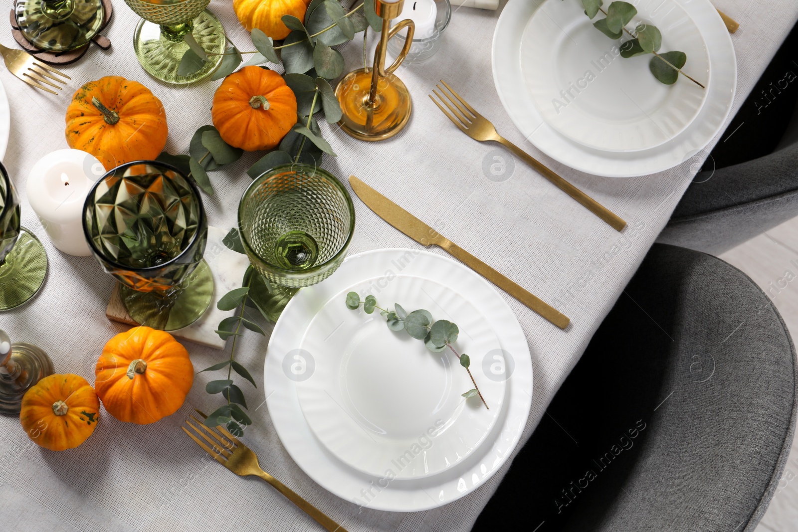 Photo of Beautiful autumn table setting. Plates, cutlery, glasses, pumpkins and floral decor, flat lay