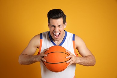 Basketball player with ball on yellow background