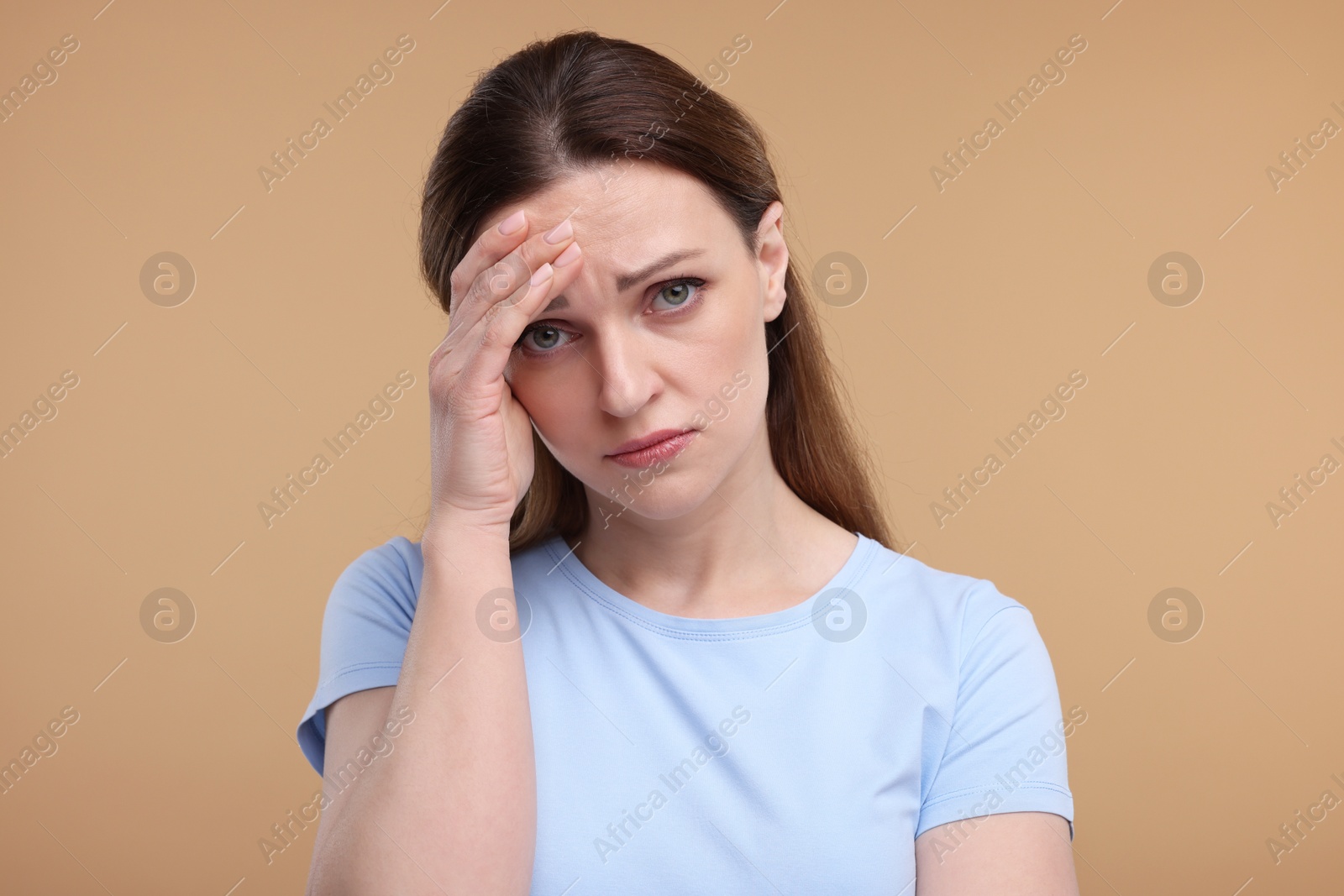 Photo of Portrait of sad woman on beige background