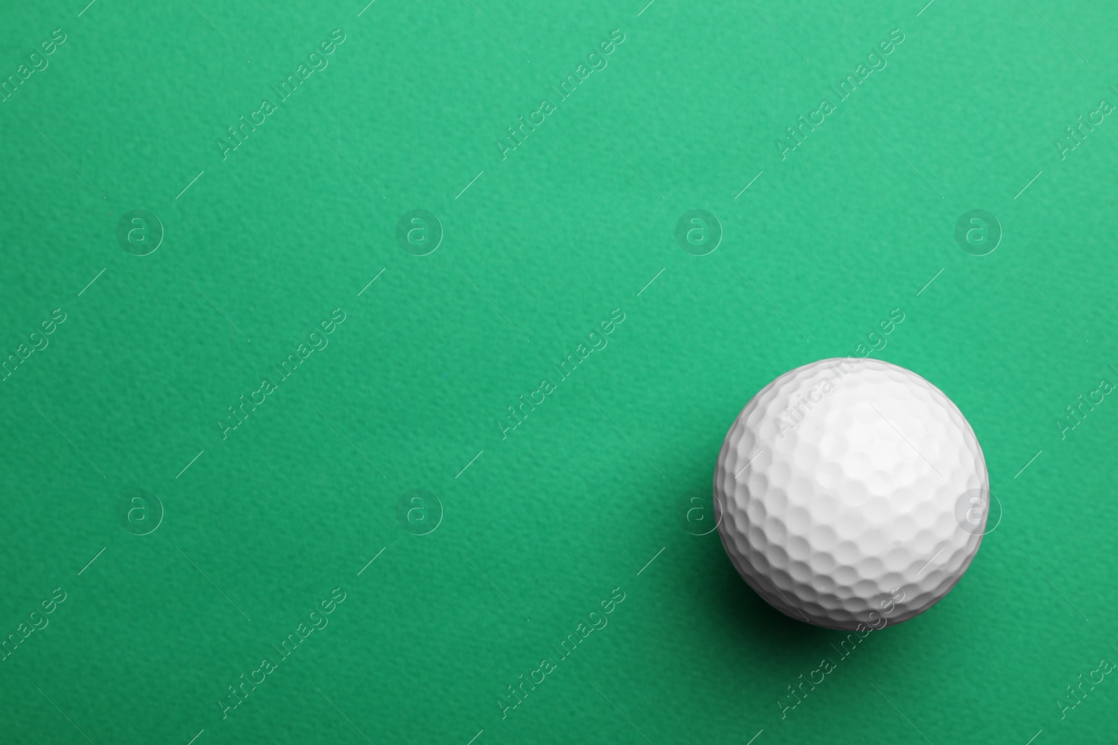 Photo of Golf ball on color background, top view. Space for text