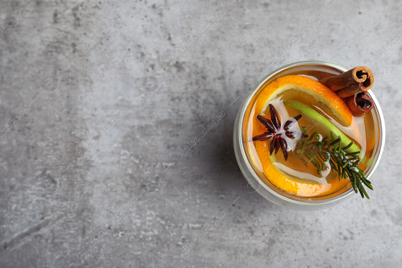 Photo of Aromatic white mulled wine on light grey table, top view. Space for text