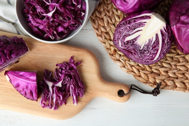 Photo of Flat lay composition with shredded red cabbage on white wooden table