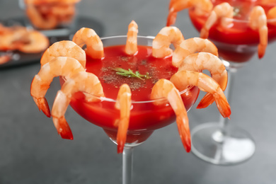 Photo of Delicious shrimp cocktail with tomato sauce, closeup