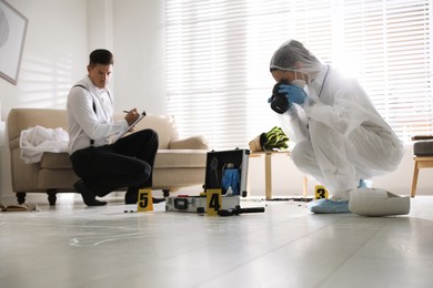 Investigators working at crime scene in living room