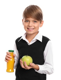 Happy boy holding bottle of juice and apple on white background. Healthy food for school lunch