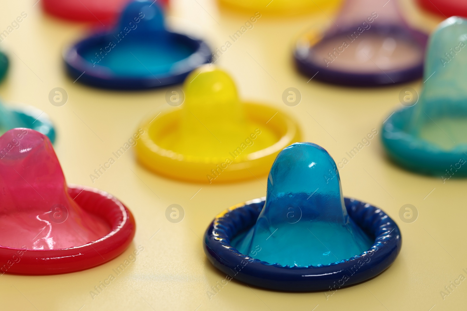 Photo of Condoms on beige background, closeup. Safe sex