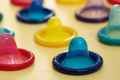 Photo of Condoms on beige background, closeup. Safe sex