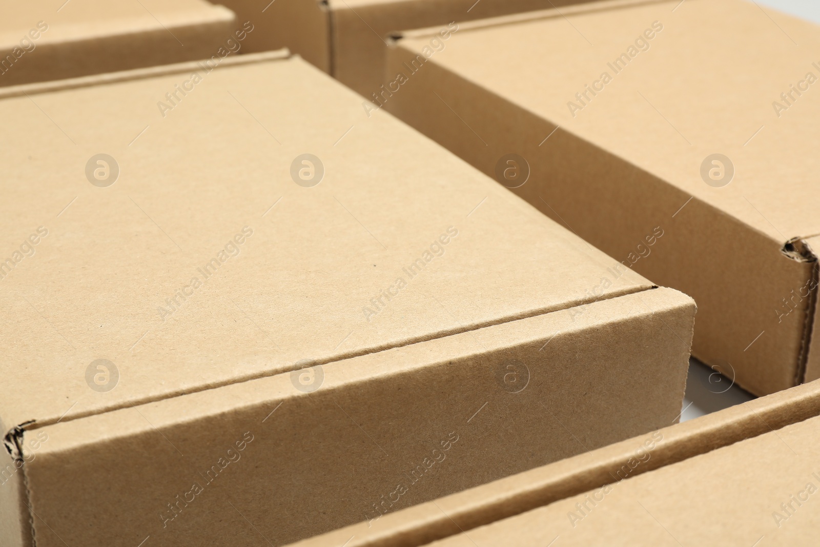 Photo of Many cardboard boxes on white background, closeup. Packaging goods