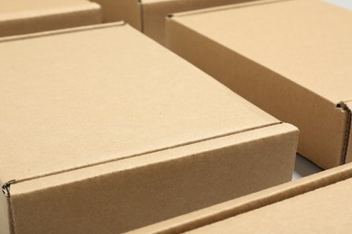 Photo of Many cardboard boxes on white background, closeup. Packaging goods