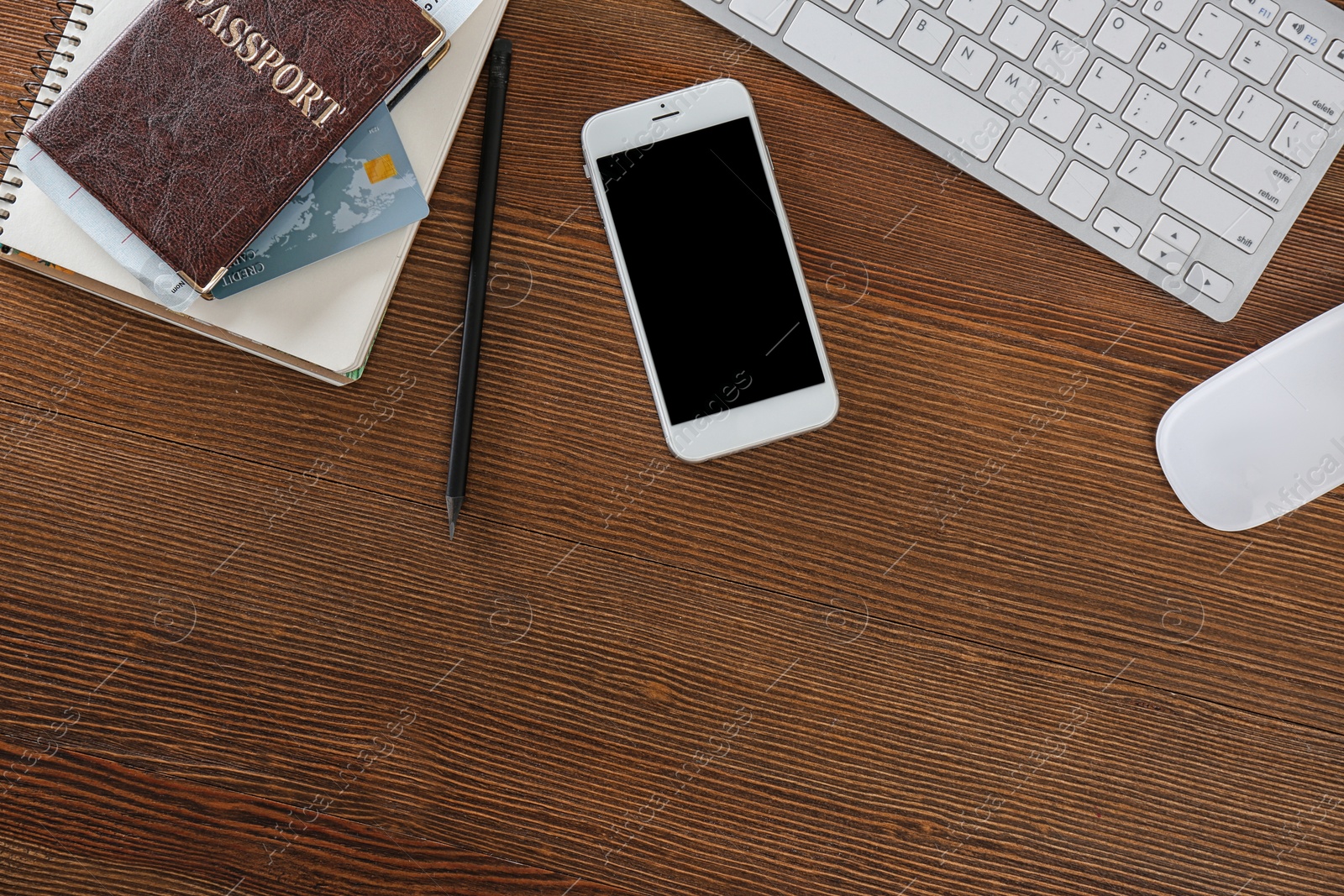 Photo of Flat lay composition with mobile phone and passport on wooden table, space for design. Travel agency concept