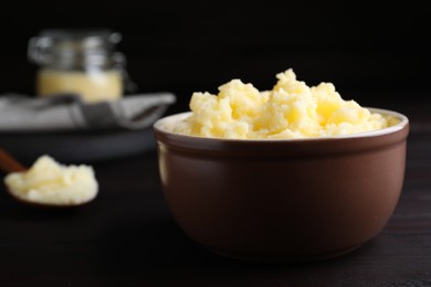 Photo of Bowl of Ghee butter on wooden table, closeup