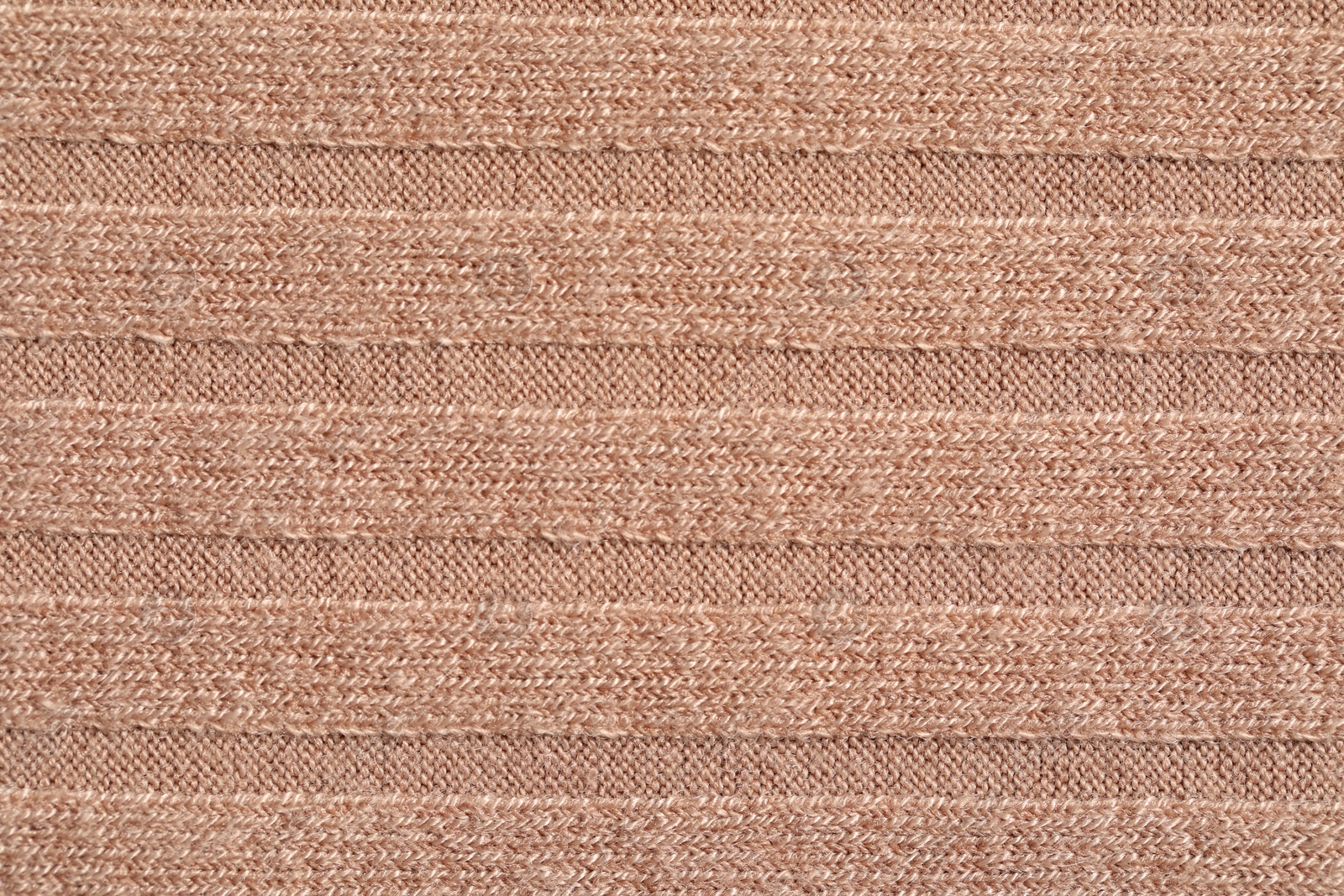 Photo of Texture of soft beige fabric as background, top view